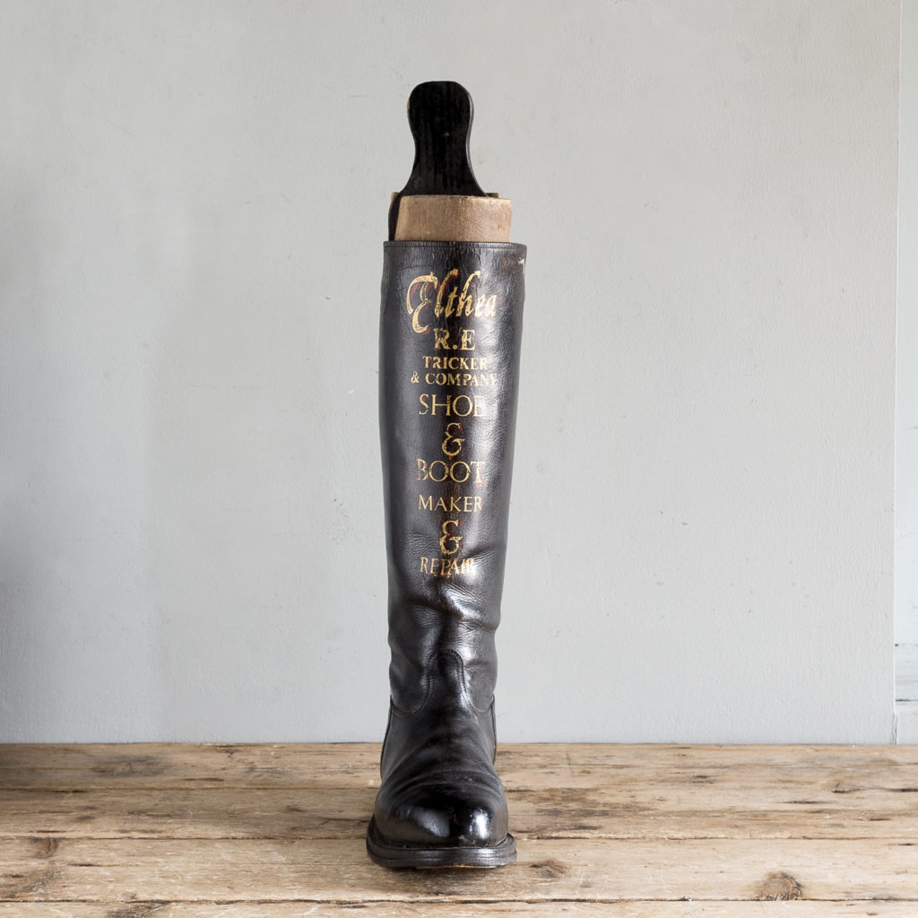 black leather boot with applied gold lettering