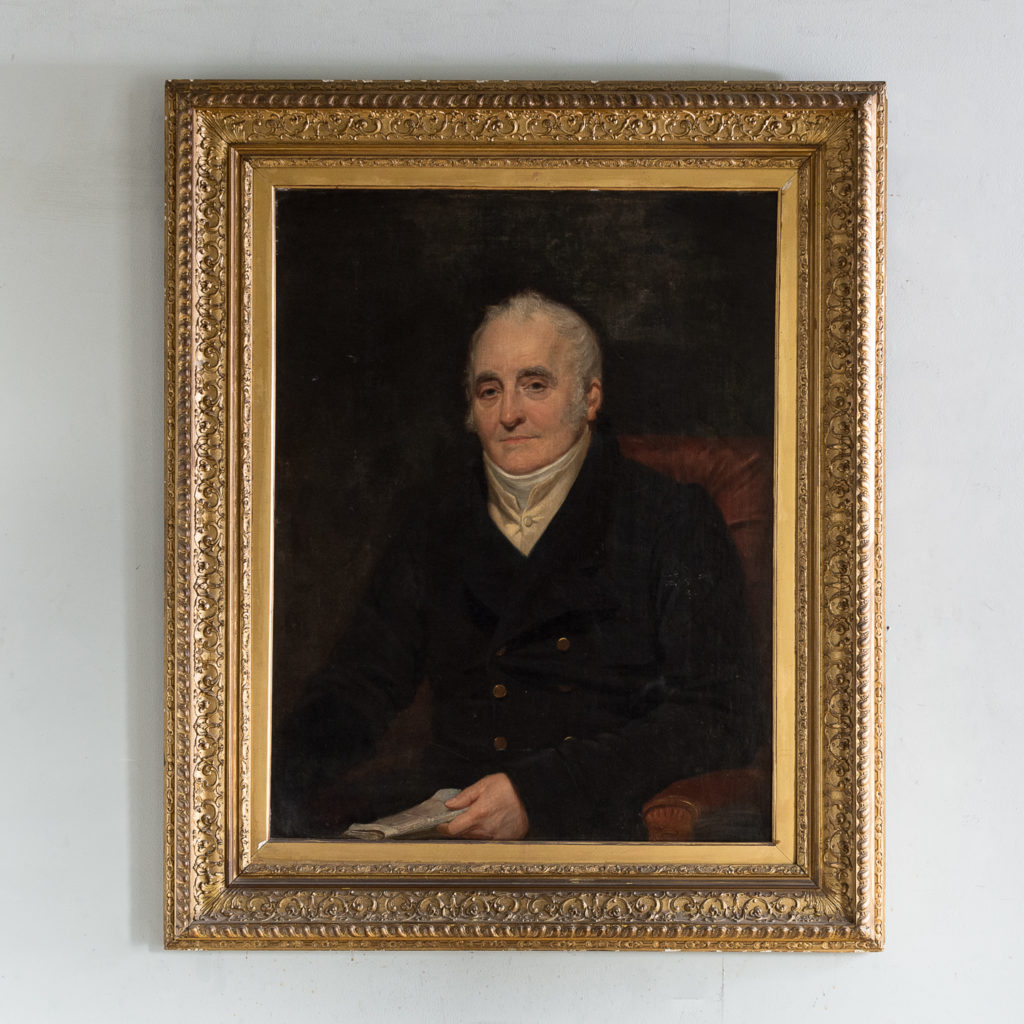 Portrait of a seated a gentleman holding papers