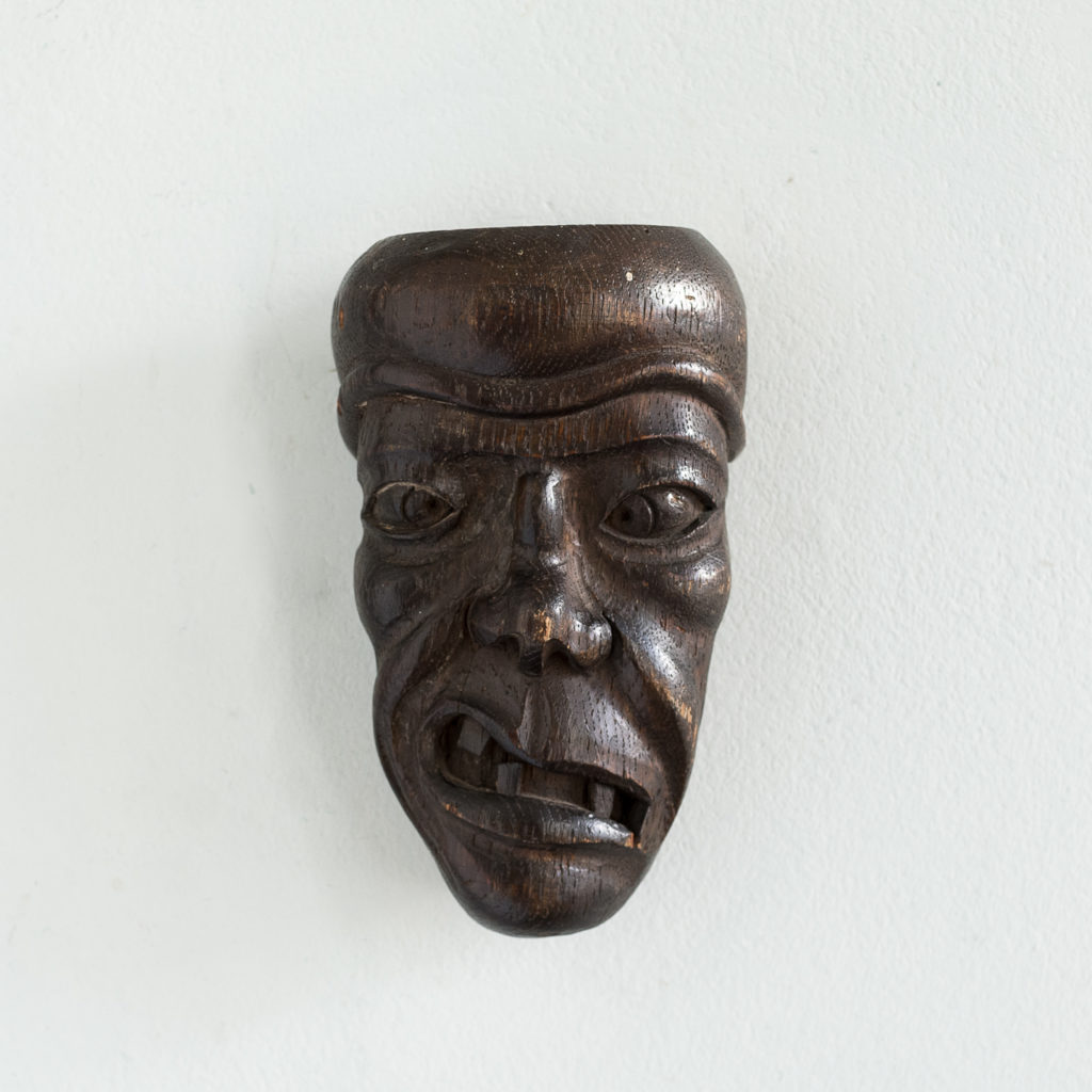 Early twentieth century carved oak grotesque mask,