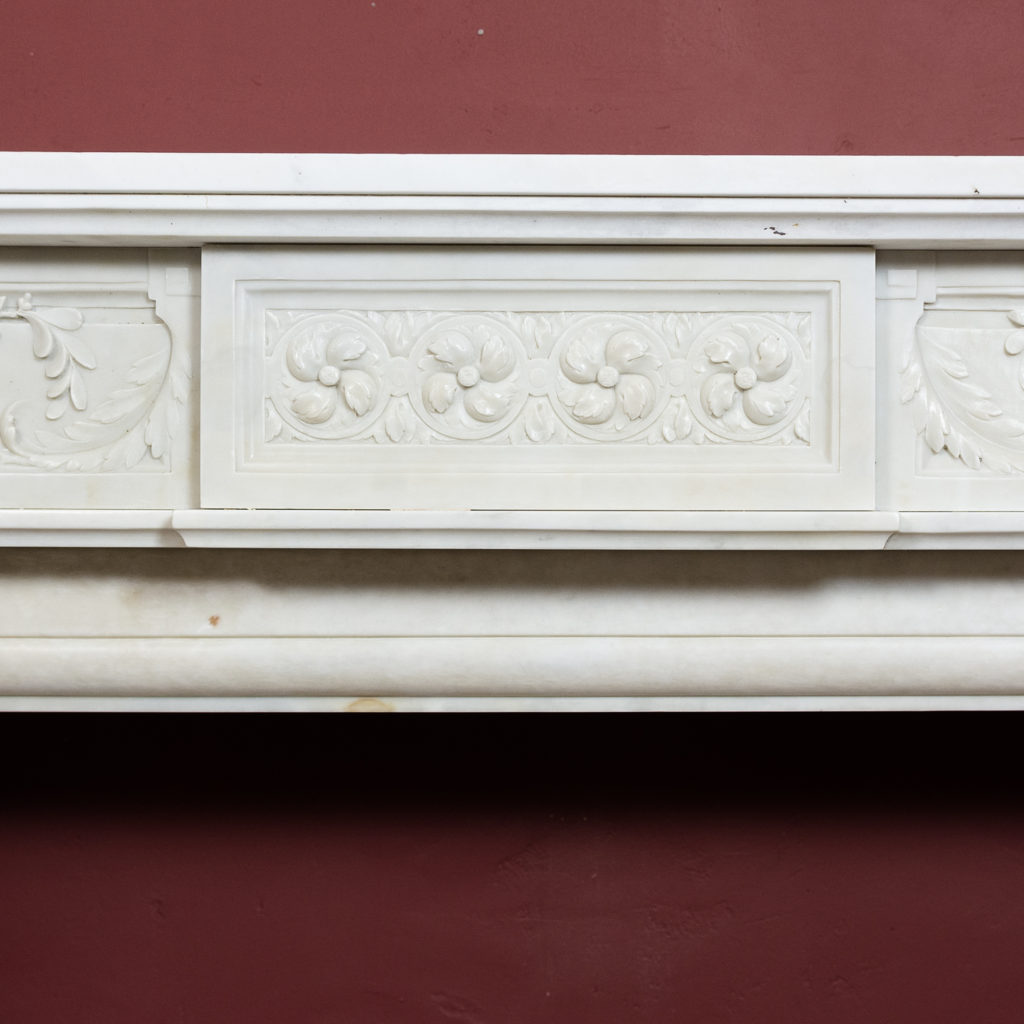 frieze centred by plaque with foliate roundels with scrolling foliage to either side