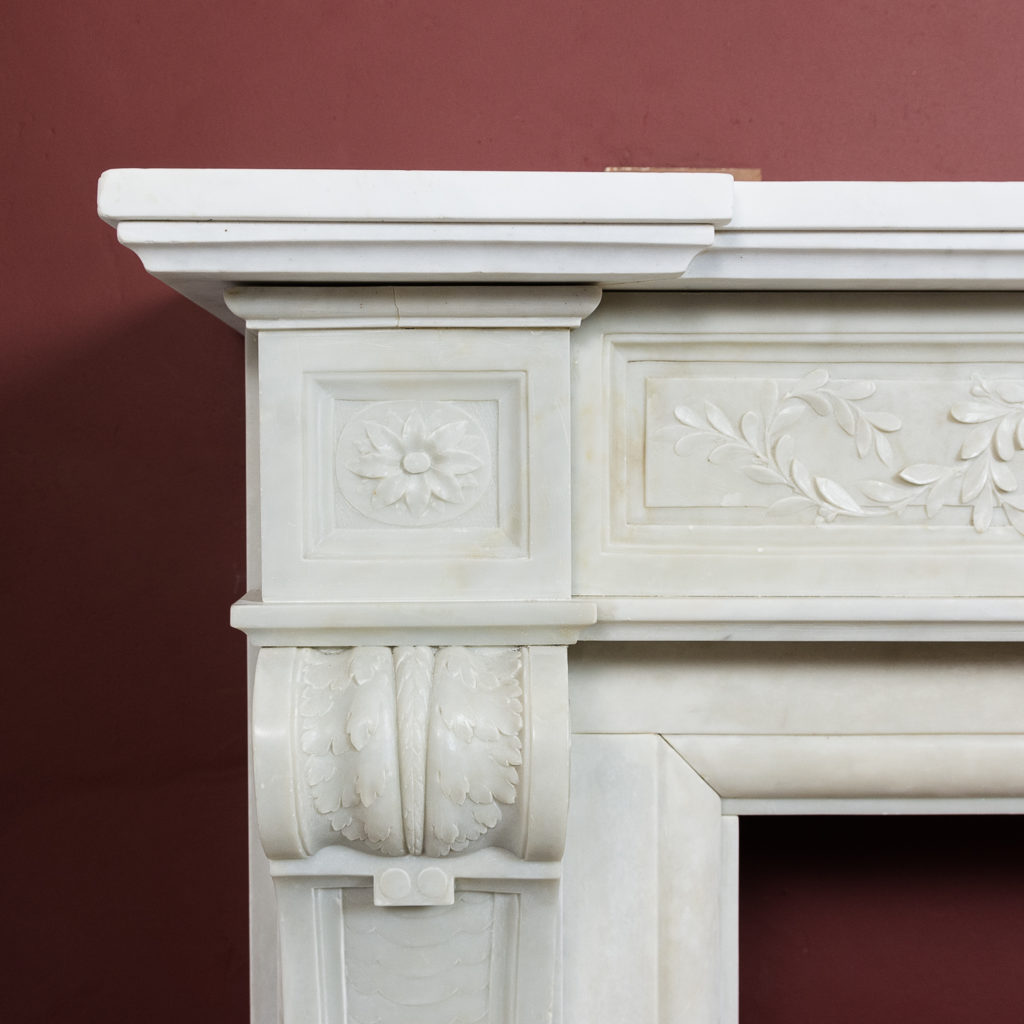 the jambs headed by paterae endblocks above foliate carved corbels,