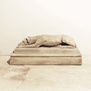 An English composition stone recumbent whippet on plinth-0