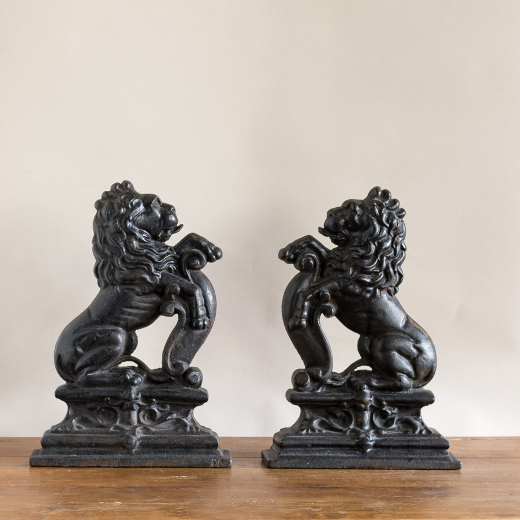 Pair of late Victorian rampant lion cast iron door stops,