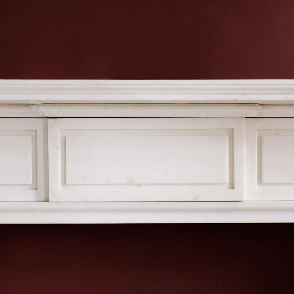 the moulded shelf above frieze with incised channel-moulded decoration and central plaque,