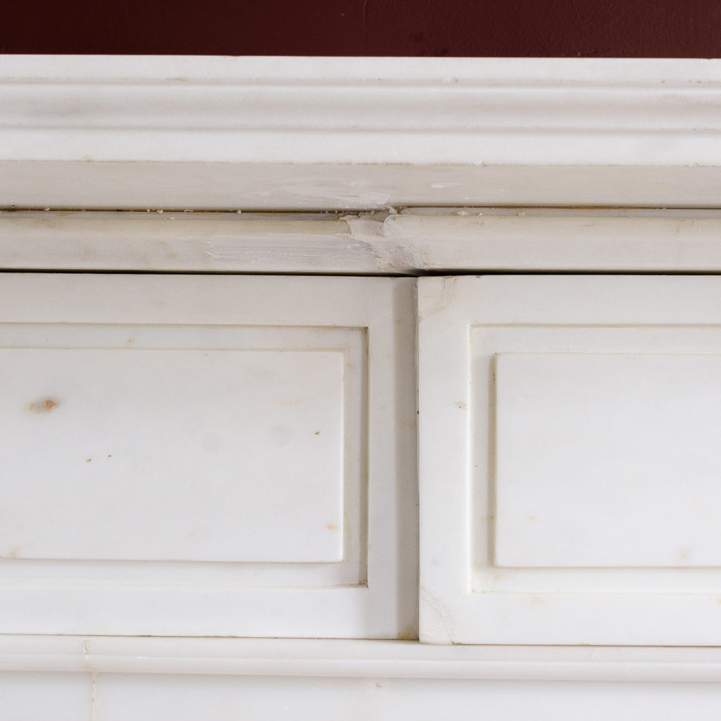 the moulded shelf above frieze with incised channel-moulded decoration and central plaque,