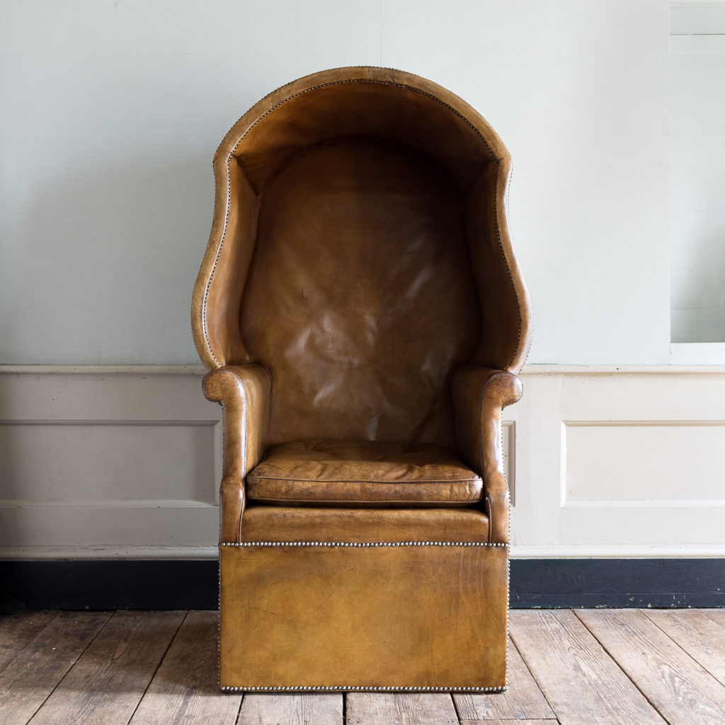 Tan leather upholstered porter’s chair,