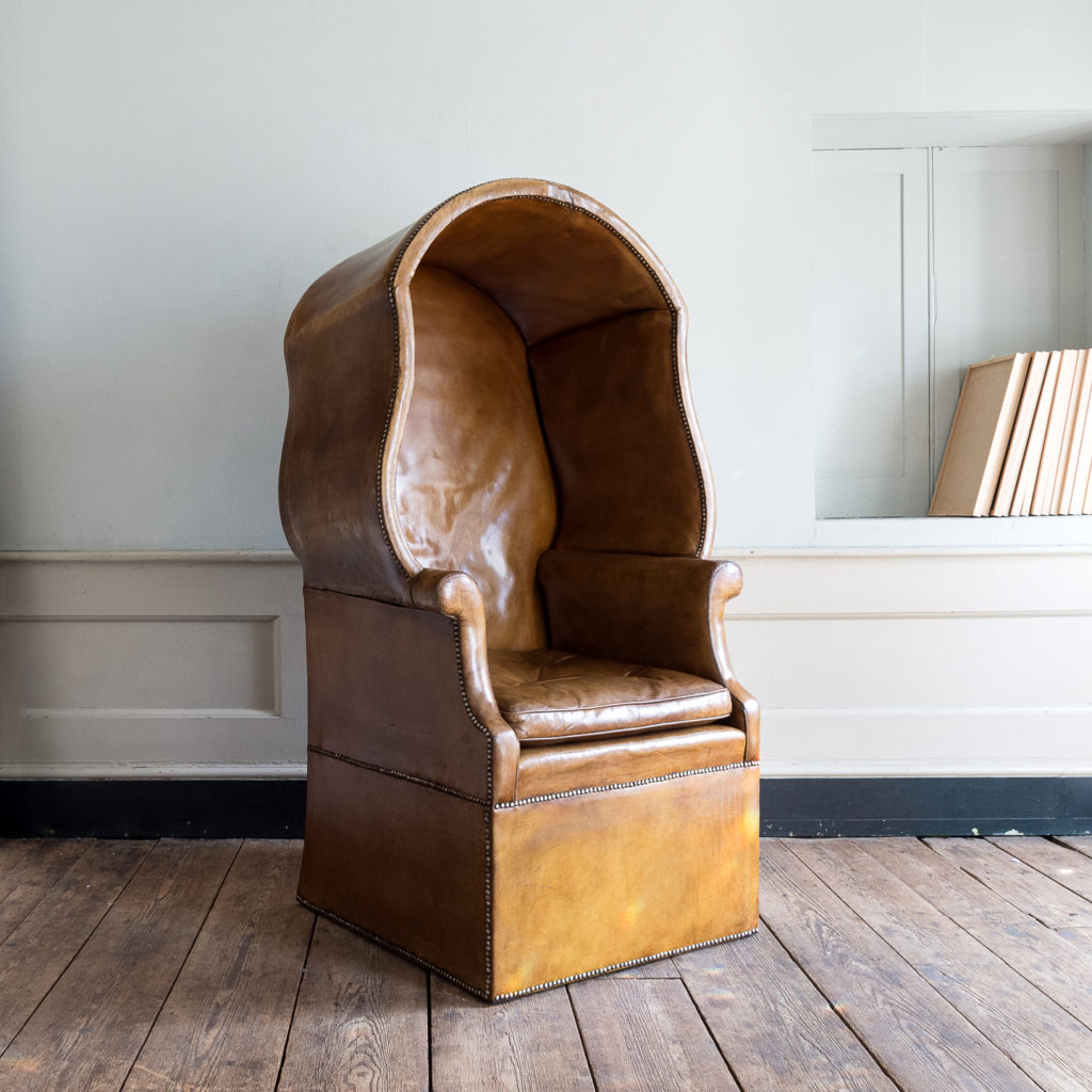 Tan leather upholstered porter’s chair,
