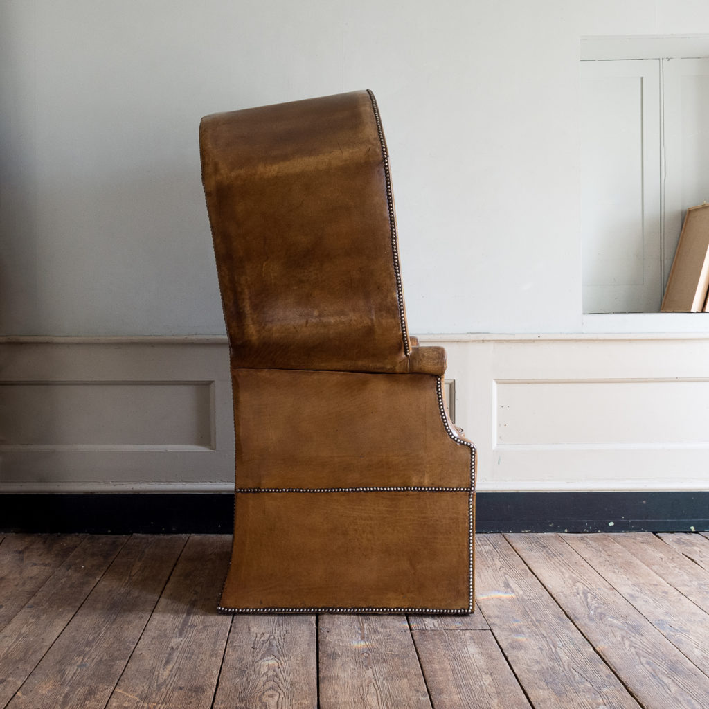 Tan leather upholstered porter’s chair,