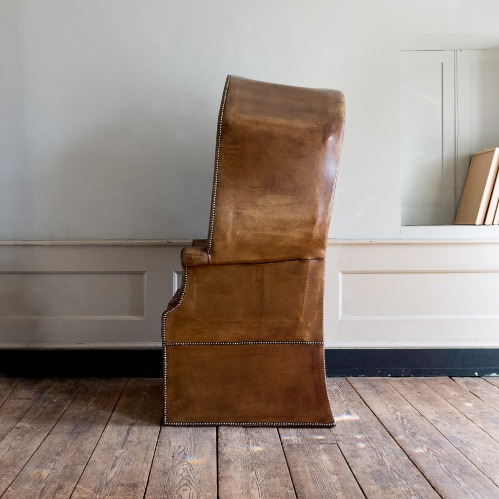 Tan leather upholstered porter’s chair,