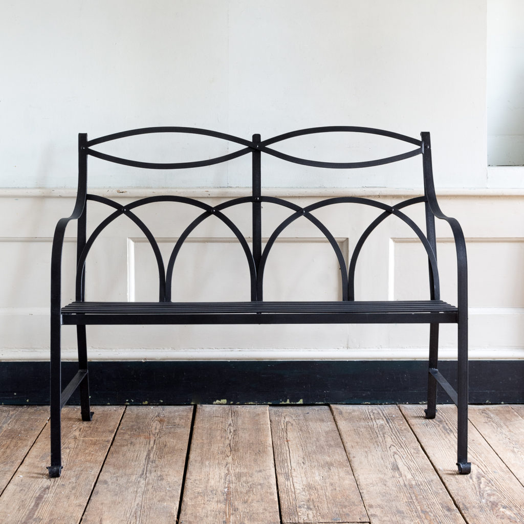 Regency style wrought iron garden bench,