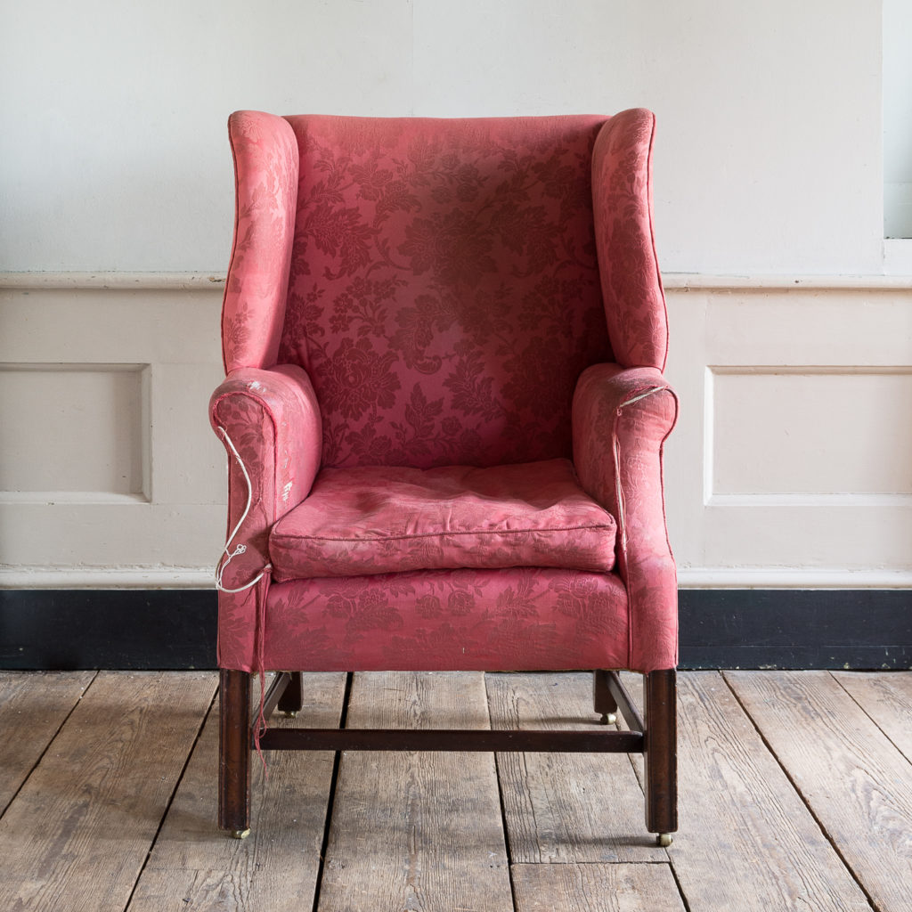 George III mahogany wingback armchair,