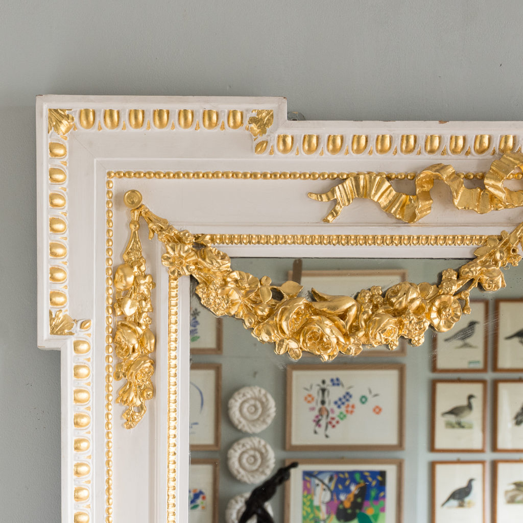 the egg and dart bordered frame hung with foliate festoons.