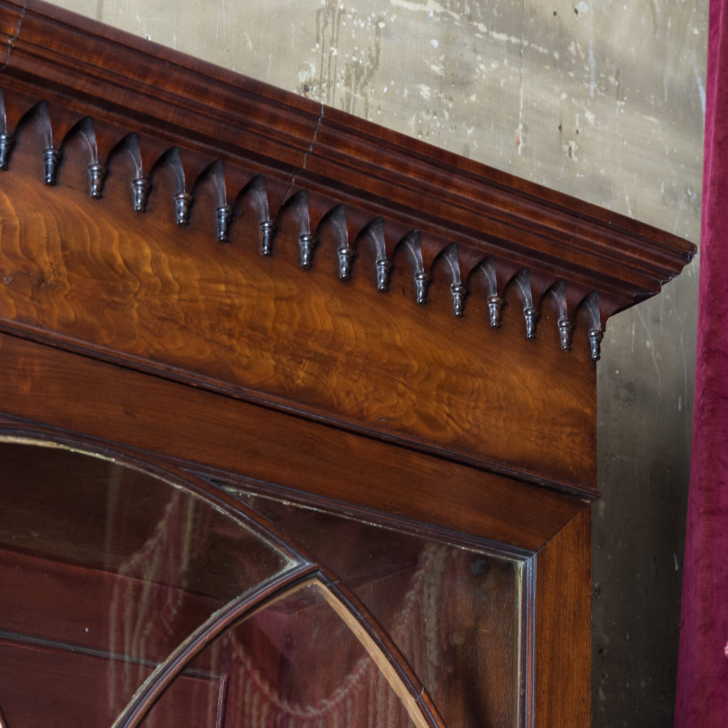 the moulded cornice above frieze hung with gothic pendants