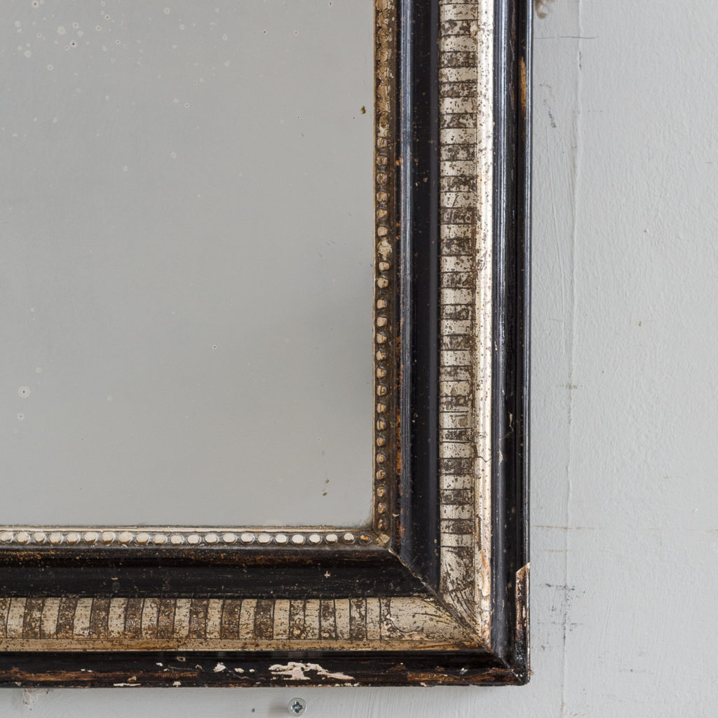 French ebonised and parcel silver-gilt wall mirror,-139997