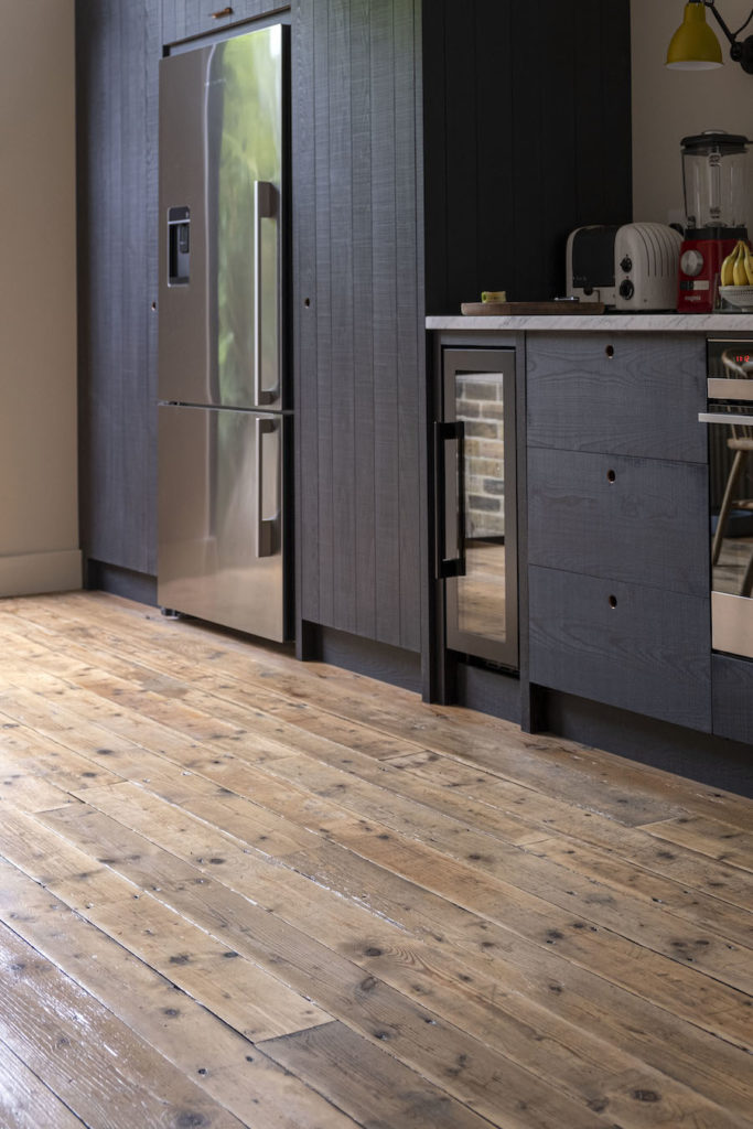 kitchen with modern cabinets and old timber