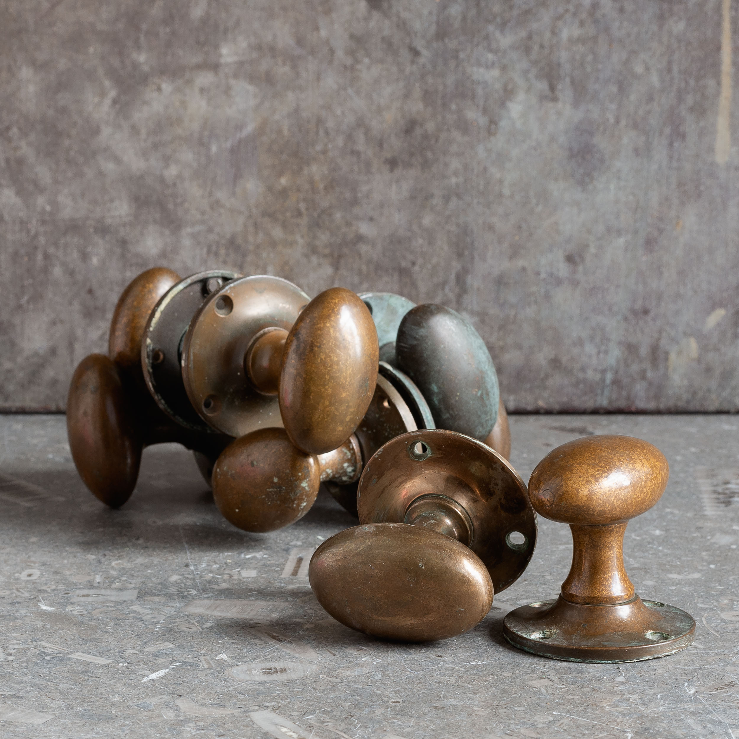 Early twentieth century patinated brass oval door knobs - LASSCO